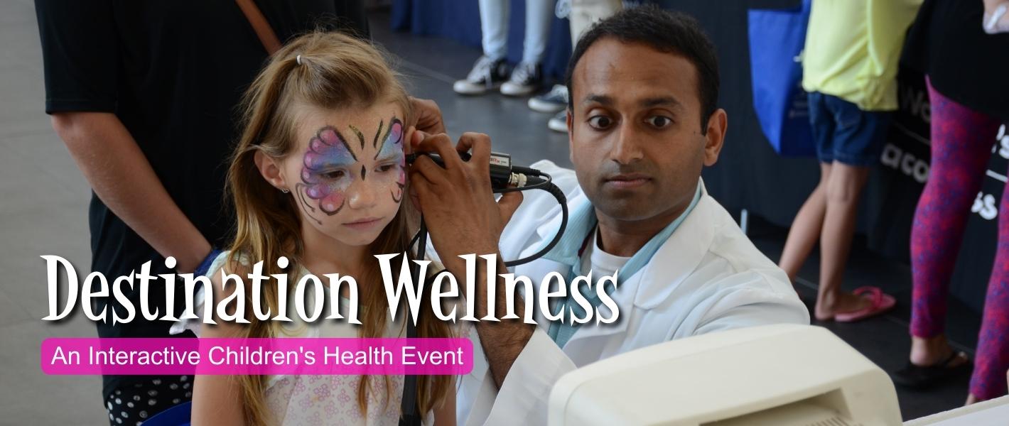 Doctor taking a look at a young girl's ear.